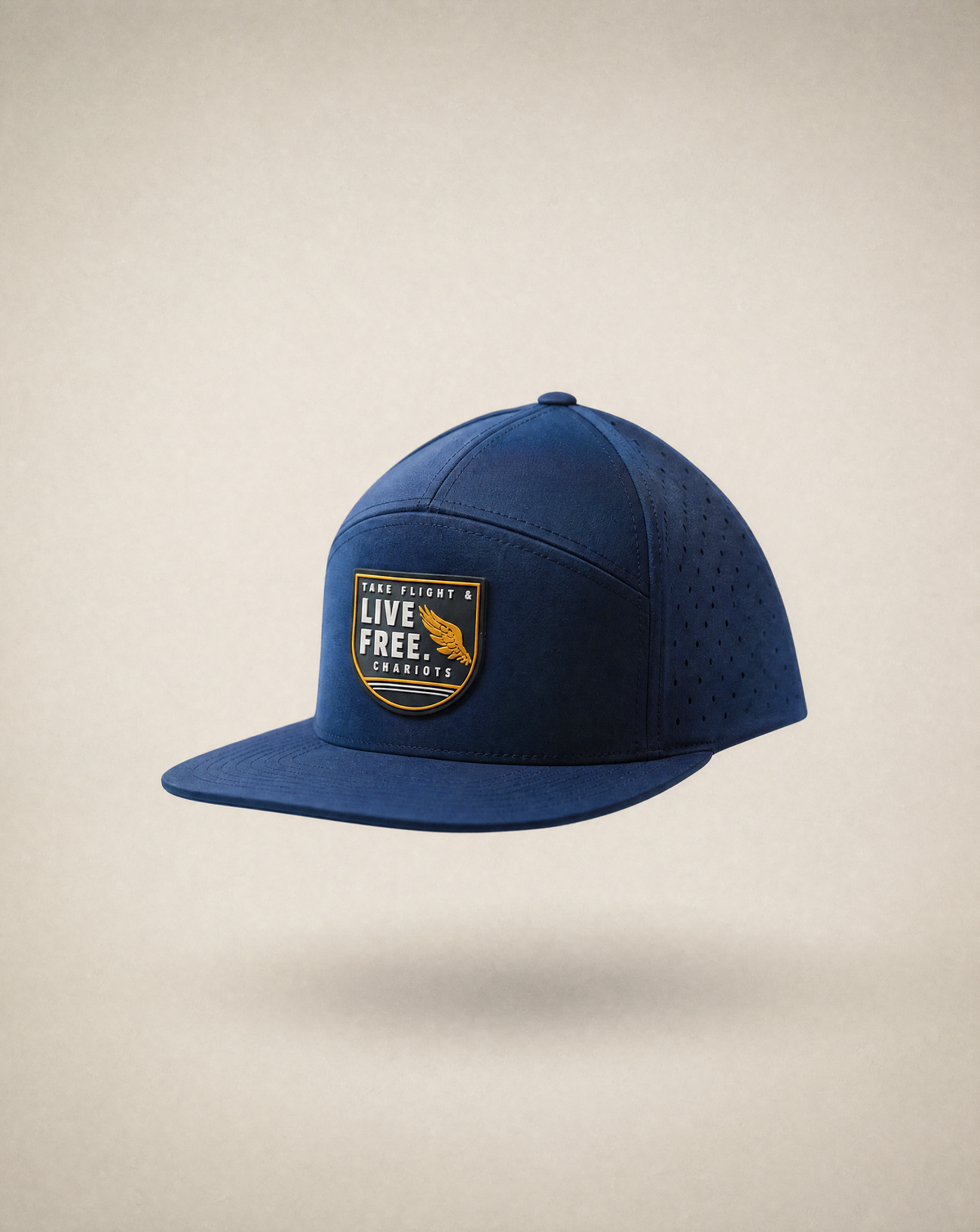 A navy blue flat-brim cap with a curved brim, featuring a front patch that reads 'LIVE FREE